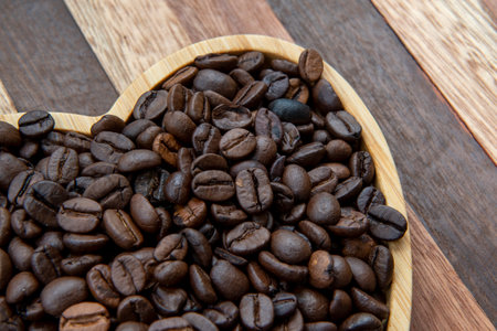 coffee beans in heart-shaped tray representing love of coffeeの写真素材