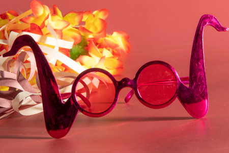 Carnival costume glasses with feathers and typical elements in the backgroundの写真素材