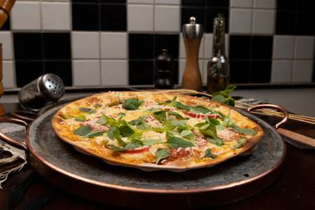 Brazilian pizza with pepperoni, cheese & arugula, top viewの写真素材