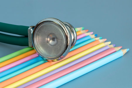 palette of colored pencils and a stethoscope representing the pediatrician doctorの写真素材