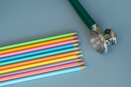 palette of colored pencils and a stethoscope representing the pediatrician doctorの写真素材