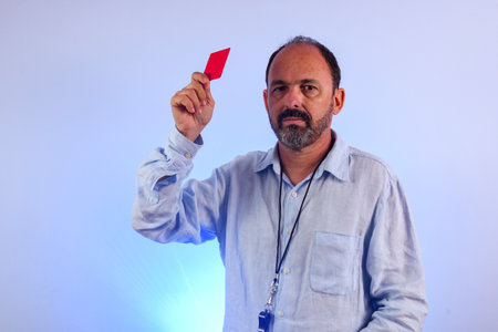 sixty year old man holding a yellow cardの写真素材