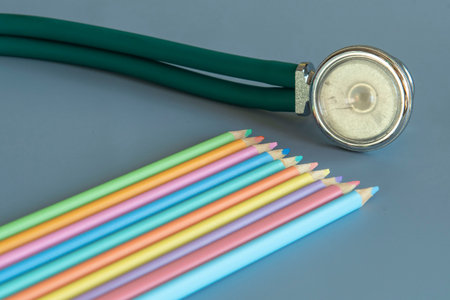 palette of colored pencils and a stethoscope representing the pediatrician doctorの写真素材