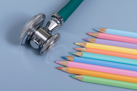 palette of colored pencils and a stethoscope representing the pediatrician doctorの写真素材