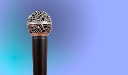 Microphone on a stand on a blue-purple background.の写真素材