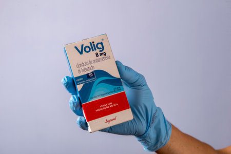 Rio, Brazil - January 27, 2023, hand with protective rubber glove holding medicine box, ondansetron hydrochloride dihydrate - Volig 8mgのeditorial素材