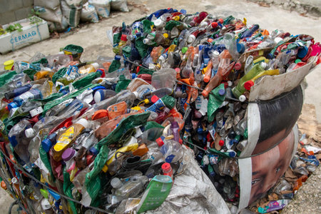 Rio, Brazil - November 26, 2022: recyclable garbage pressing into big balesのeditorial素材