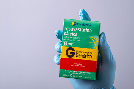 Rio, Brazil - January 27, 2023, hand with protective rubber glove holding medicine box, rosuvastatin calciumのeditorial素材