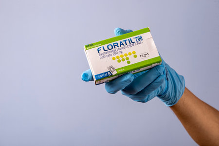 Rio, Brazil - January 27, 2023, hand with protective rubber glove holding medicine box, saccharomyces boulardii - Floratil 200mgのeditorial素材