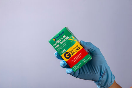 Rio, Brazil - January 27, 2023, doctor hand with protective rubber glove holding medicine box of cipofloxacin hydrochlorideのeditorial素材