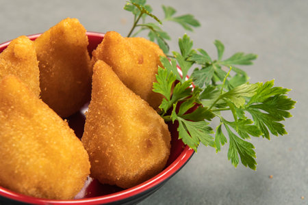 traditional fried coxinha in plate on slate background, popular brazilian snack served at partiesの写真素材