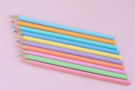 Pastel colored pencils, top view on pink background, illustration concept, background and education and back to schoolの写真素材
