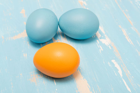 Colorful easter eggs on a blue wooden background. Toned.