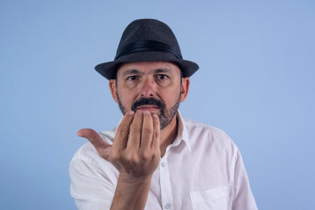 Portrait of 60 years old bearded man, on blue backgroundの写真素材