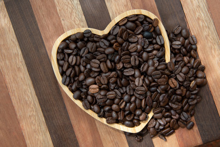 coffee beans in heart-shaped tray representing love of coffeeの写真素材