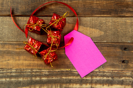 christmas decorative elements next to card with red ribbon and copy spaceの写真素材