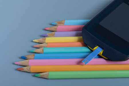 Back to school concept for kids with diabetes represented by colored pencils and glucometerの写真素材