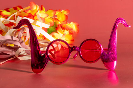 Carnival costume glasses with feathers and typical elements in the backgroundの写真素材