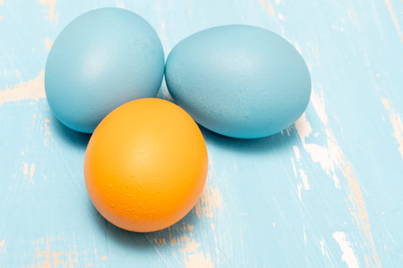 Colorful easter eggs on a blue wooden background. Toned.の写真素材