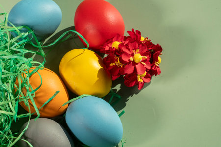 Easter eggs and flowers on green background. Happy Easter concept.の写真素材
