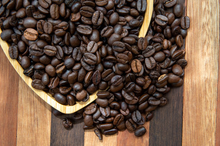 coffee beans in wooden bowl on wooden background. topview.の写真素材
