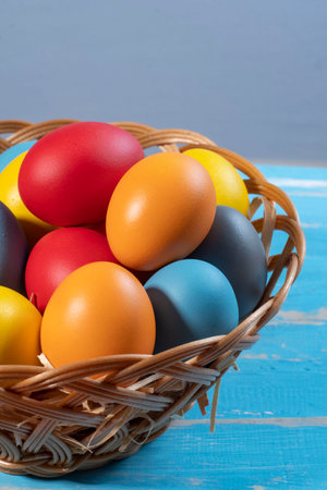 easter basket with straw and colored eggs to symbolize a religious momentの写真素材