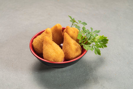 traditional fried coxinha in plate on slate background, popular brazilian snack served at partiesの写真素材
