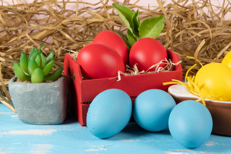 eggs in wooden box with hay on rustic background or surface, easter or holiday concept, high angle viewの写真素材