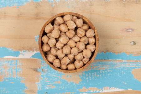 bowl with chickpea on blue rustic wooden table, top viewの写真素材