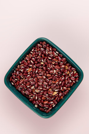 Red azuki bean (Japanese red bean) in bowl isolated on pink background with clipping path. Top view. Flat posture.の写真素材