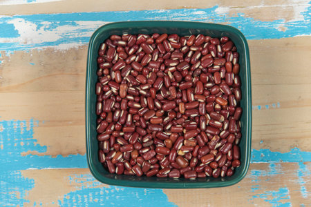 Red kidney beans in a bowl on wooden background. Top view.の写真素材