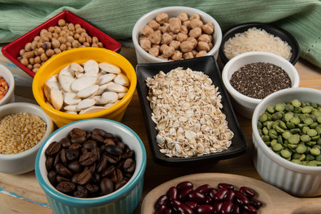 Different types of vegetables in bowls, green and yellow peas, chickpeas, colored beans and lentils, beans, top viewの写真素材