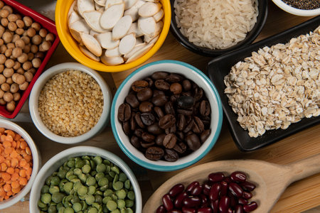 Different types of vegetables in bowls, green and yellow peas, chickpeas, colored beans and lentils, beans, top viewの写真素材