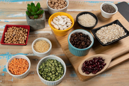 Different types of vegetables in bowls, green and yellow peas, chickpeas, colored beans and lentils, beans, top viewの写真素材