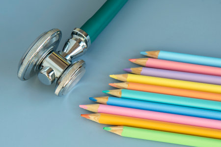 palette of colored pencils and a stethoscope representing the pediatrician doctorの写真素材