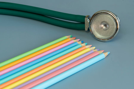 Stethoscope and colored pencils on a blue background. Selective focus.の写真素材
