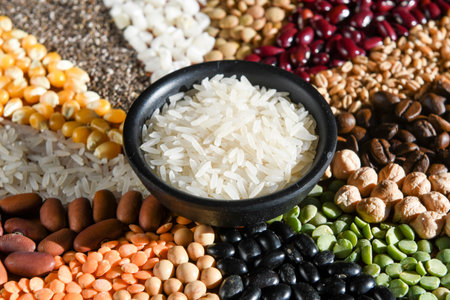 Bowl with raw white rices on various seedsの写真素材