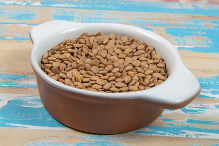 bowl with lentils on blue rustic wooden table, up viewの写真素材