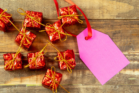 christmas decorative elements next to card with red ribbon and copy spaceの写真素材