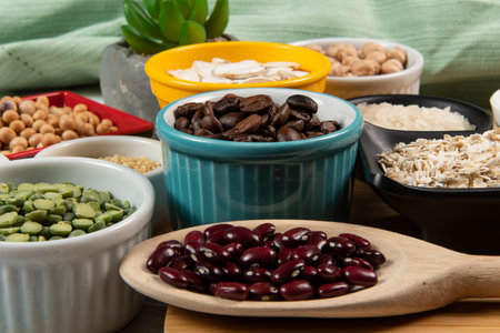 Different types of vegetables in bowls, green and yellow peas, chickpeas, colored beans and lentils, beans, top viewの写真素材