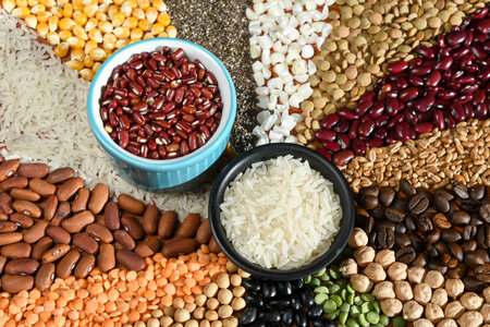 Bowl with raw white rices and beans on various seedsの写真素材