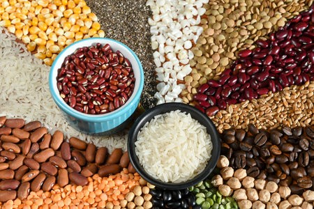 Bowl with raw white rices and beans on various seedsの写真素材