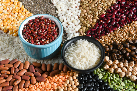 Bowl with raw white rices and beans on various seedsの写真素材