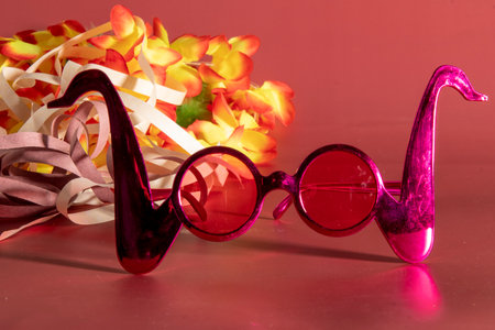 Carnival costume glasses with feathers and typical elements in the backgroundの写真素材
