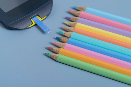 Back to school concept for kids with diabetes represented by colored pencils and glucometerの写真素材