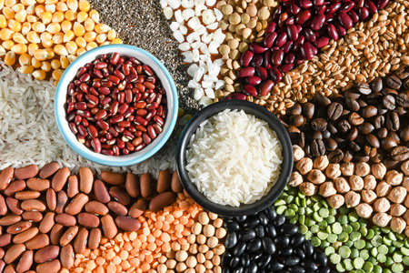 Bowl with raw white rices and beans on various seedsの写真素材