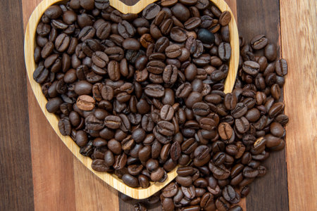 coffee beans in heart-shaped tray representing love of coffeeの写真素材