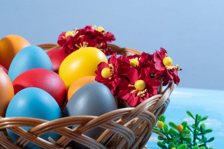 easter basket with straw and colored eggs to symbolize a religious momentの写真素材