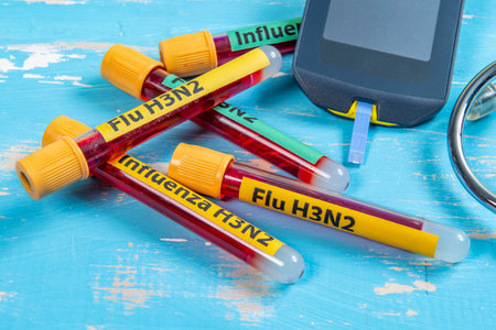 Glucose meter and test tubes with blood sample for diabetes testの写真素材