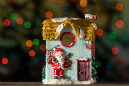 Gingerbread house with christmas decoration on bokeh backgroundの写真素材